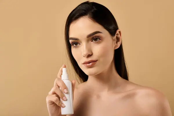 A young woman shares her skincare routine, showcasing her glowing complexion in a studio. — Stock Photo