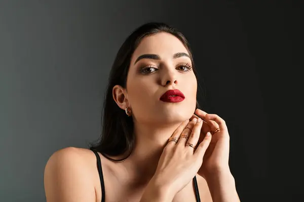 A young woman with brown hair and red lips radiates elegance and confidence. — Stock Photo