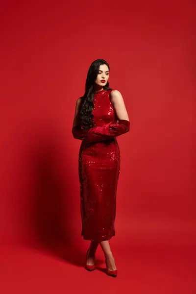 A young woman in a red dress and gloves creates an alluring atmosphere. — Stock Photo