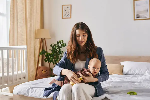 Loving mother celebrate Mothers Day with her baby in a warm, joyful home. — Stock Photo