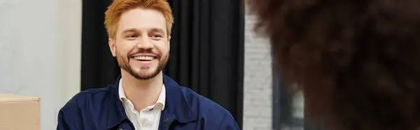 Cheerful individual engages in light conversation during the packing and unpacking of boxes. — Stock Photo