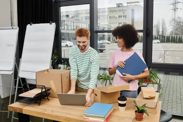 Las personas se centran en sus tareas de organización y desembalaje en un entorno de oficina contemporáneo. - foto de stock