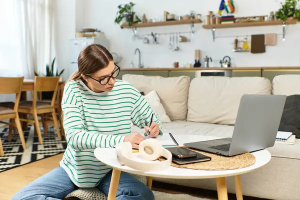 Young woman works creatively at home in a stylish, well lit space. — Stock Photo