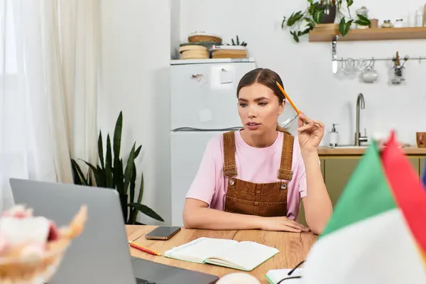 Young woman in casual attire pondering her ideas while working at a stylish desk setup. — Stock Photo