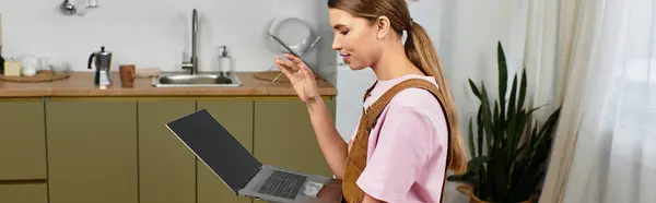 Una giovane, bella donna gode di una conversazione vivace mentre seduto in una cucina elegante. — Foto stock
