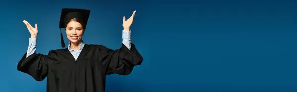 A young beautiful woman expresses joy and excitement while wearing a graduation cap and gown. — Stock Photo