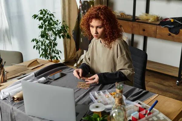 A young woman focuses on creating unique jewelry pieces in her stylish home workspace. — Stock Photo