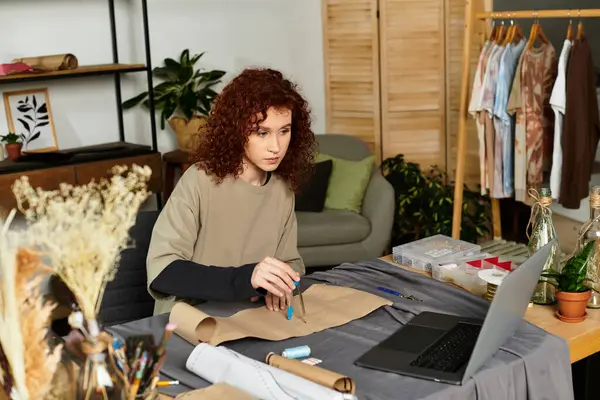Creative woman engaged in a DIY project at her modern workspace filled with plants and tools — Stock Photo