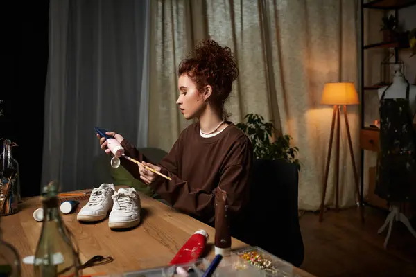 A young woman showcases her craft skills during a DIY project at her modern workspace. — Stock Photo