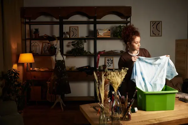A craftswoman works on a DIY project, organizing fabric in her cozy workshop. — Stock Photo