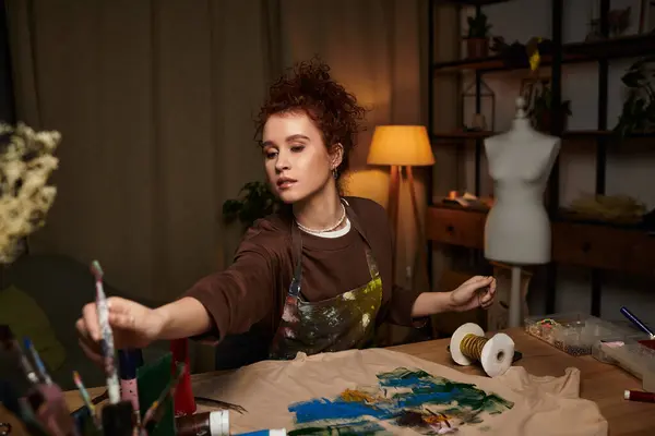 Talented craftswoman creates beautiful designs in her warm, inviting workspace filled with tools. — Stock Photo