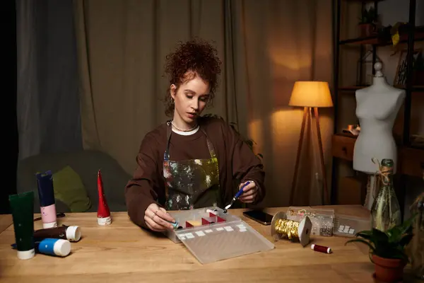 A craftswoman skillfully works on a DIY project at her organized table in a cozy room. — Stock Photo