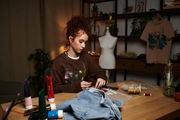 In a craft studio, a young woman passionately works on DIY projects with colorful supplies. — Stock Photo