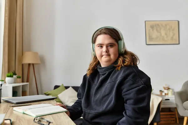A young woman with Down syndrome relaxes comfortably at home, immersed in a laid back vibe. — Stock Photo