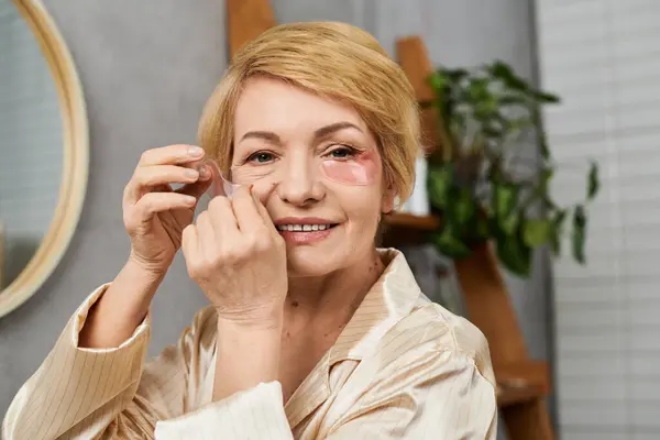 Senior woman with a radiant smile engages in her self care routine, enhancing her beauty. — Stock Photo