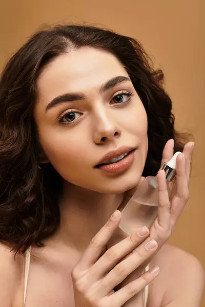 A pretty young woman with braces showcases her skincare routine in a vibrant studio atmosphere. — Stock Photo