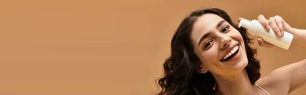 Young woman with braces shares her glowing skincare routine in a bright studio, banner — Stock Photo