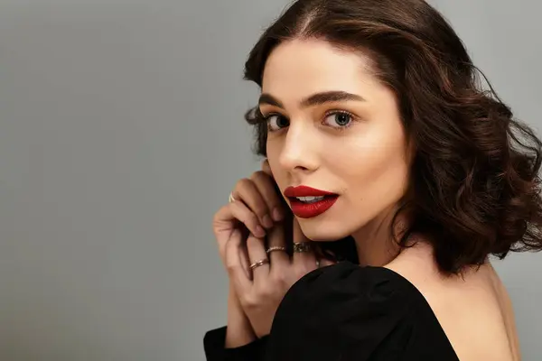 A stunning young woman showcases her radiant red lips and braces while enjoying a graceful pose. — Stock Photo