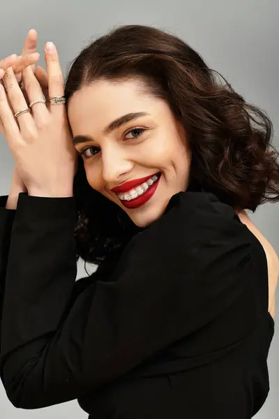 A beautiful young woman poses with confidence, showcasing her braces and vibrant red lips. — Stock Photo