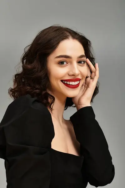A young woman showcases her confidence with a radiant smile, highlighting her braces and red lips. — Stock Photo