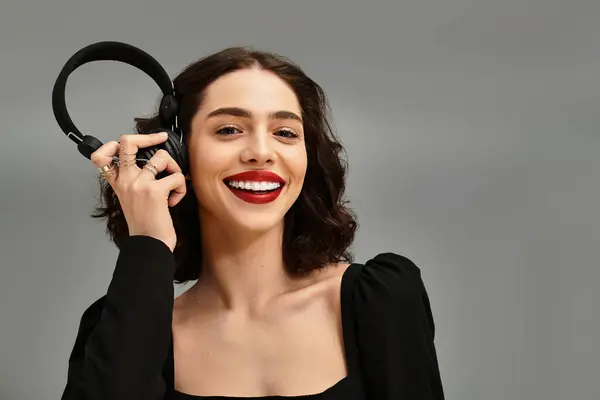 A confident young woman showcases her radiant red lips and braces, enjoying a moment of joy. — Stock Photo
