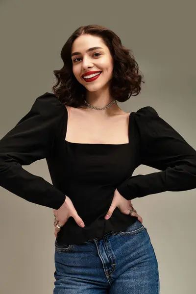 Brightly smiling woman with braces and red lips poses confidently against a grey background. — Stock Photo