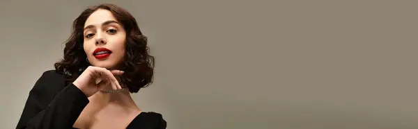 A confident young woman poses with braces and bright red lips against a gray background, banner — Stock Photo
