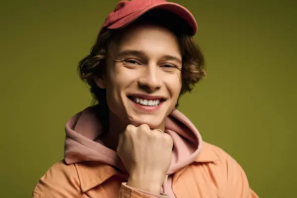A stylish young man poses confidently with a bright smile, showcasing his modern look. — Stock Photo