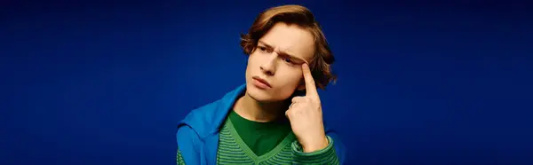 A handsome young man models trendy attire with confidence and an expressive gesture. — Stock Photo