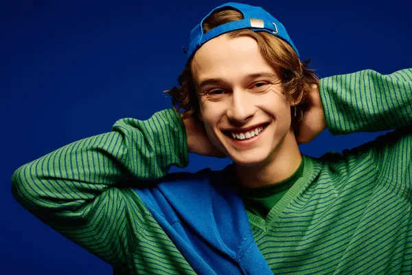 Bright colors and a confident vibe radiate as a stylish young man poses with an engaging smile. — Stock Photo