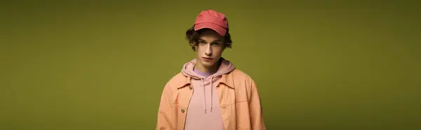 A young man exudes confidence in stylish attire, merging youthful energy with modern fashion. — Stock Photo