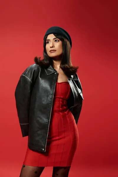 Stylish young Asian woman poses confidently against a bold red backdrop. — Stock Photo