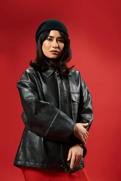 A young asian woman confidently poses in trendy attire, exuding style and modern flair. — Stock Photo
