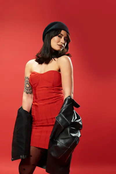 Chic woman in a red dress exudes modern style, youthful energy, and fierce confidence. — Stock Photo