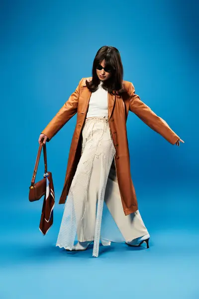 Confident young Asian woman in trendy outfit with a chic brown coat and stylish accessories. — Stock Photo
