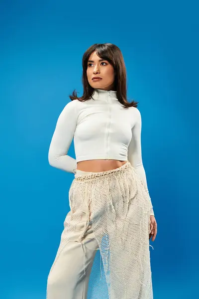 A young woman in chic attire poses confidently, embodying contemporary fashion and youth culture. — Stock Photo