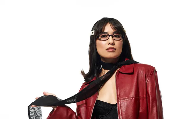 Young Asian woman confidently poses in a vibrant red jacket and trendy accessories. — Stock Photo