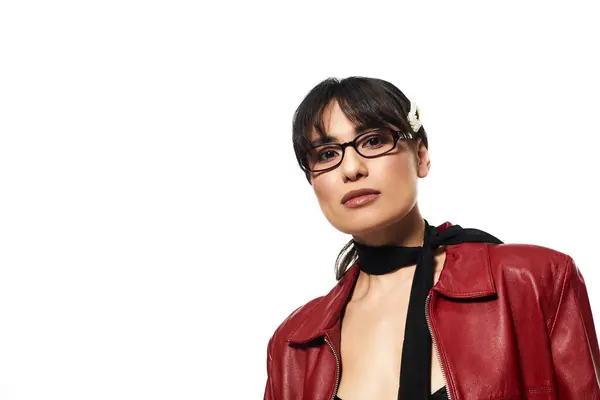 A young asian woman confidently poses in a chic red leather jacket, embodying modern style trends. — Stock Photo