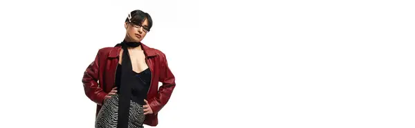 Stylish young woman confidently poses in chic attire against a minimalist backdrop. — Stock Photo