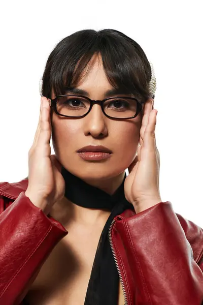 Confident young Asian woman poses in trendy attire against a white backdrop. — Stock Photo