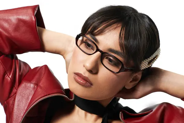 A young asian woman elegantly poses in a trendy red jacket, exuding confidence and style. — Stock Photo