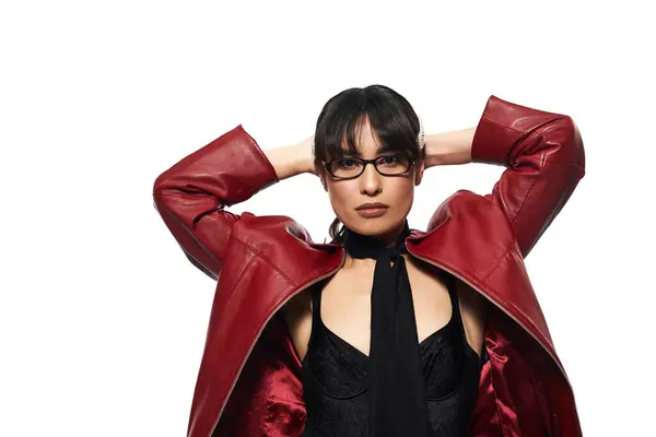 Confident young asian woman in a red statement jacket and chic attire poses in a stylish manner. — Stock Photo