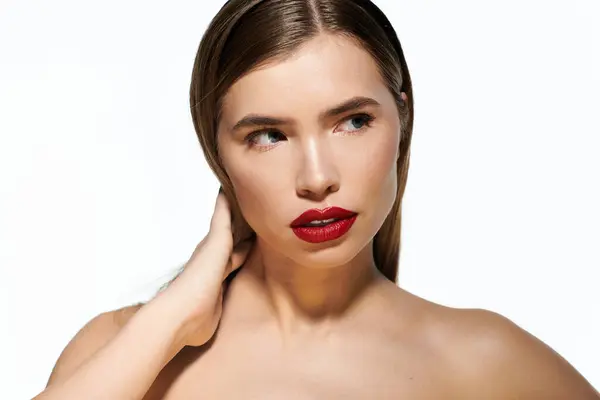 A young woman with long hair poses gracefully, highlighting her vibrant red lips and stylish look. — Stock Photo