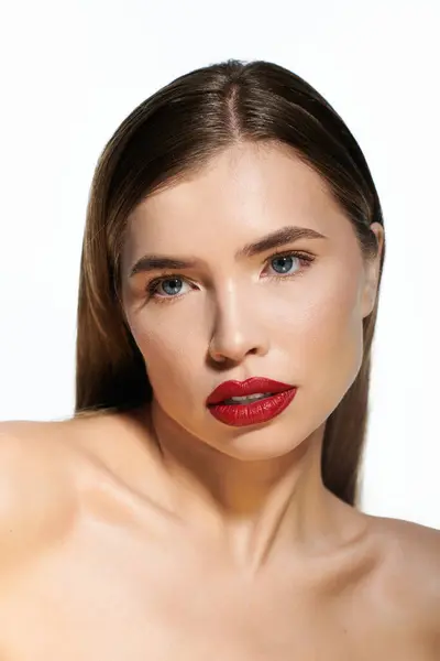 Confident young woman with glossy red lips shines in a bright setting, radiating beauty. — Stock Photo