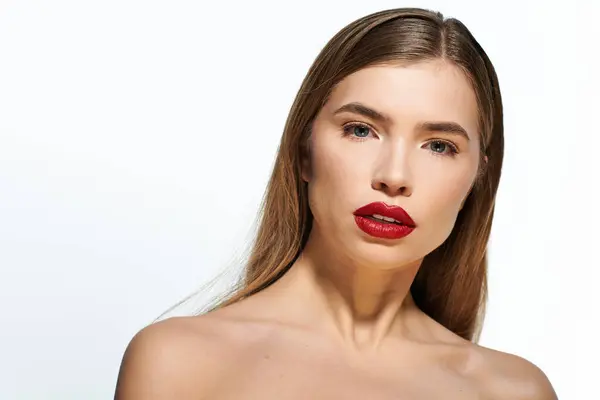 A beautiful young woman with red lips and flowing hair exudes confidence and style. — Stock Photo