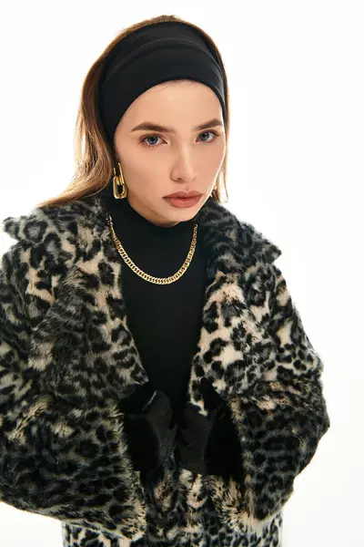 A beautiful young woman showcases her fashion sense in a stylish fur coat with a chic hairstyle. — Stock Photo