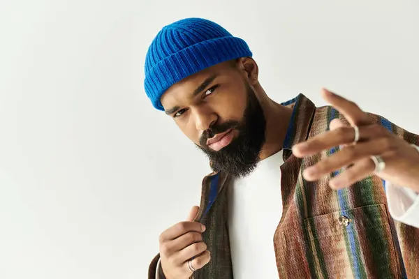 A stylish young man poses confidently, showcasing his charm and unique fashion sense. — Stock Photo