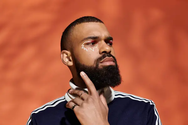 A stylish young man with a well groomed beard poses confidently in trendy attire. — Stock Photo