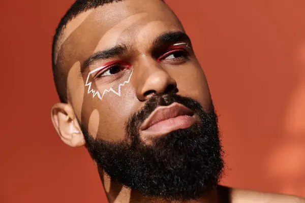 A handsome young man displays his unique style with bold makeup and striking expressions. — Stock Photo