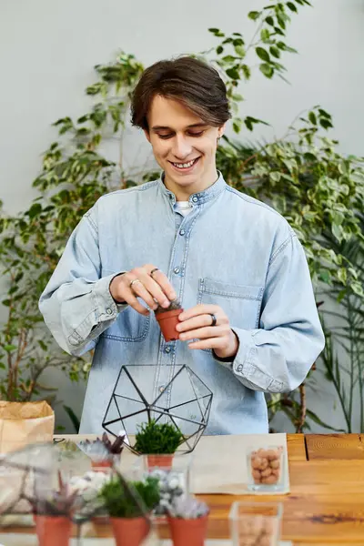 A young artist joyfully plants greenery, embracing creativity in an artistic setting. — Stock Photo